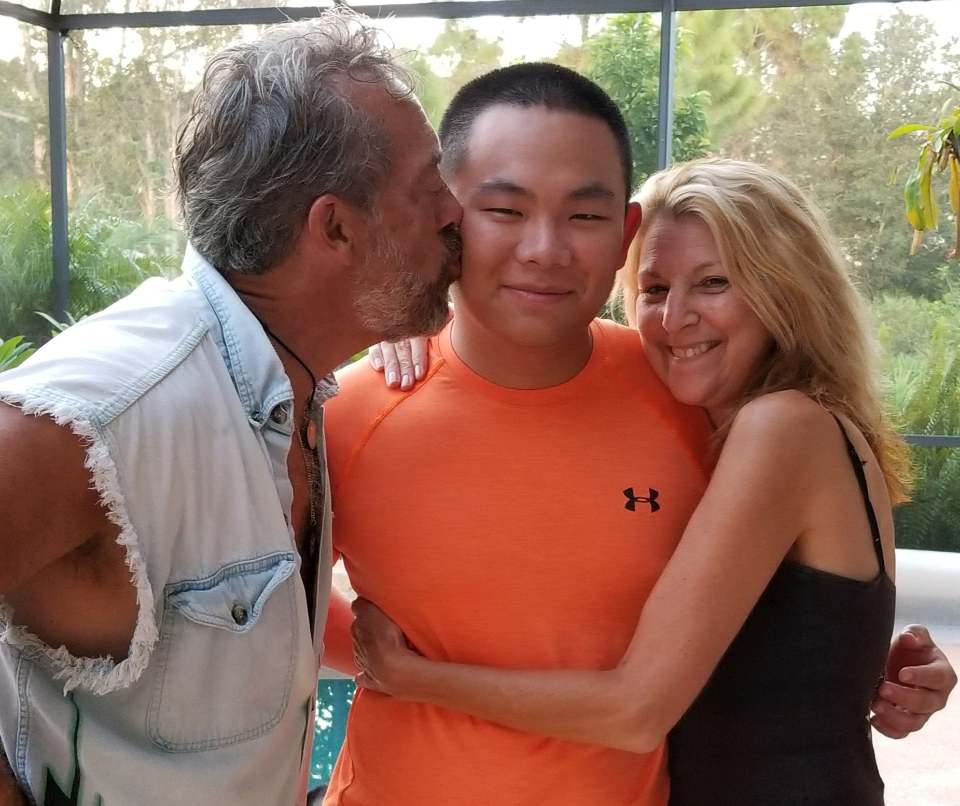 Xinhua Mesenburg is seen with his mom and dad