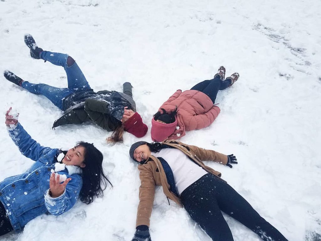 Olivia Wolf with students in snow