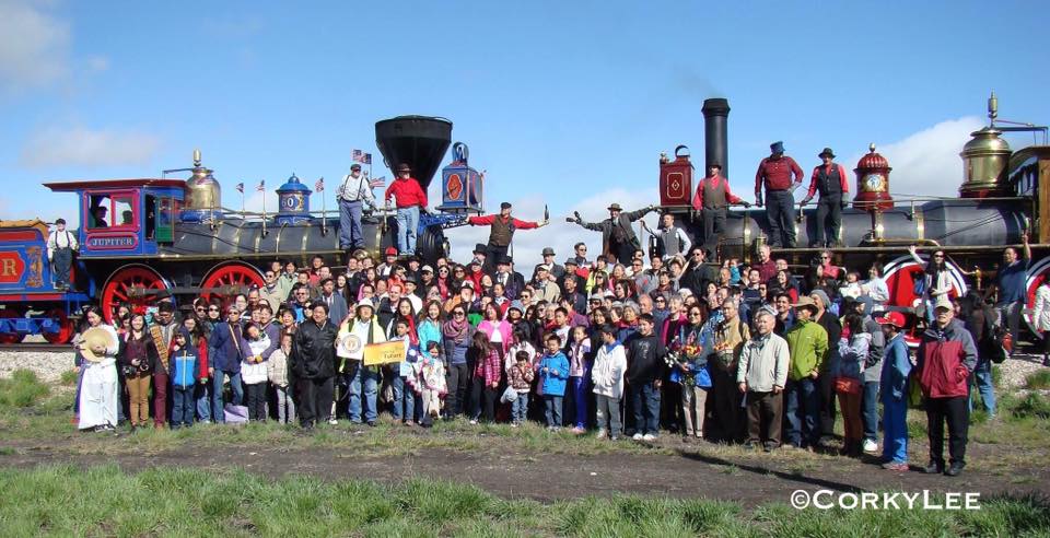 Chinese Americans re-create an historic photograph taken at the completion of the Transcontinental Railroad that excluded Chinese workers