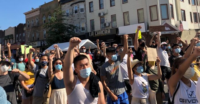 Protesters raise fists at Asian Unity Rally in Brooklyn