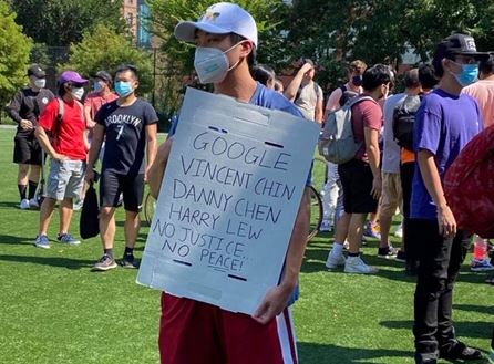 Protester holds sign that reads Google Vincent Chin, Danny Chien, Harry Lew. No Justice. No Peace