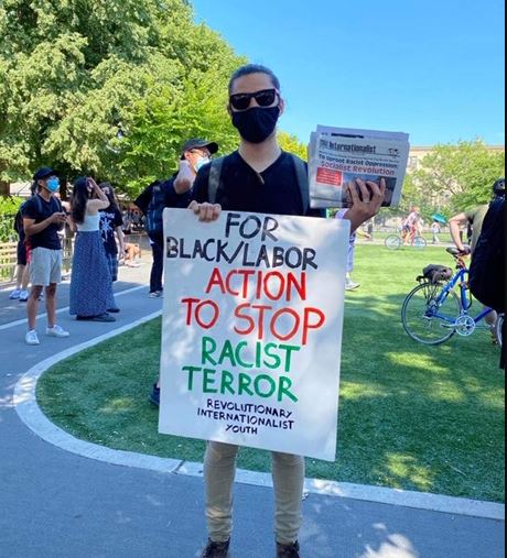 Protester holds up sign that reads "for Black/Labor action to stop racist terror sign at Asian Unity Rally
