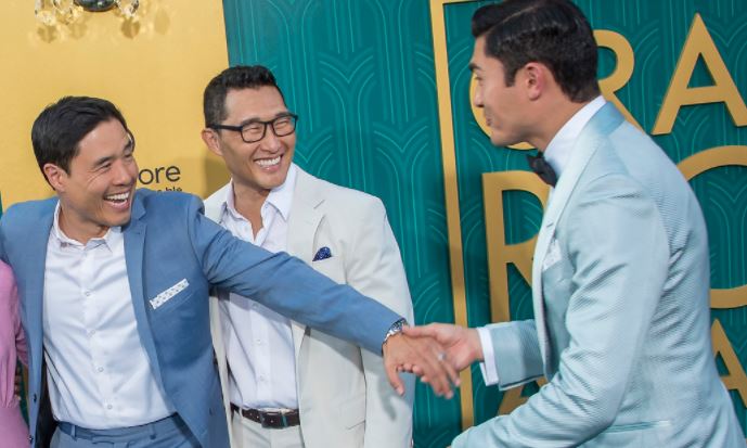 Randall Park and Daniel Dae Kim greet Henry Golding at debut of Crazy Rich Asians. Photo by Tom Sorensen via Flickr Creative Commons https://www.flickr.com/photos/moovieboy/