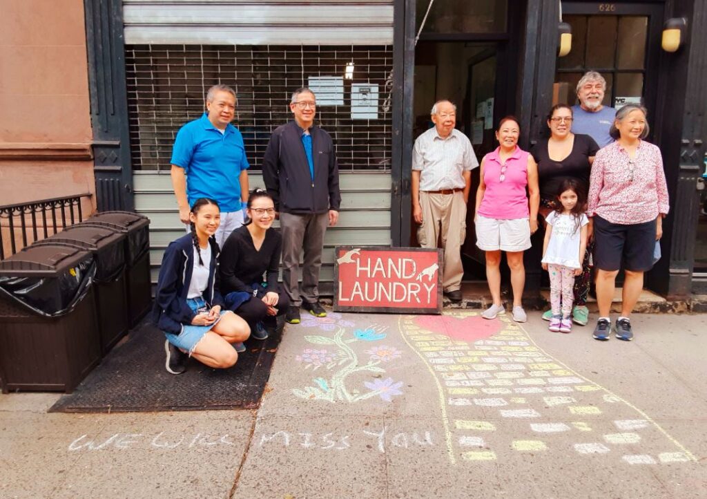 A chalk drawing says it all in front of Sun Laundry: "We will miss you." Photo by Corky Lee