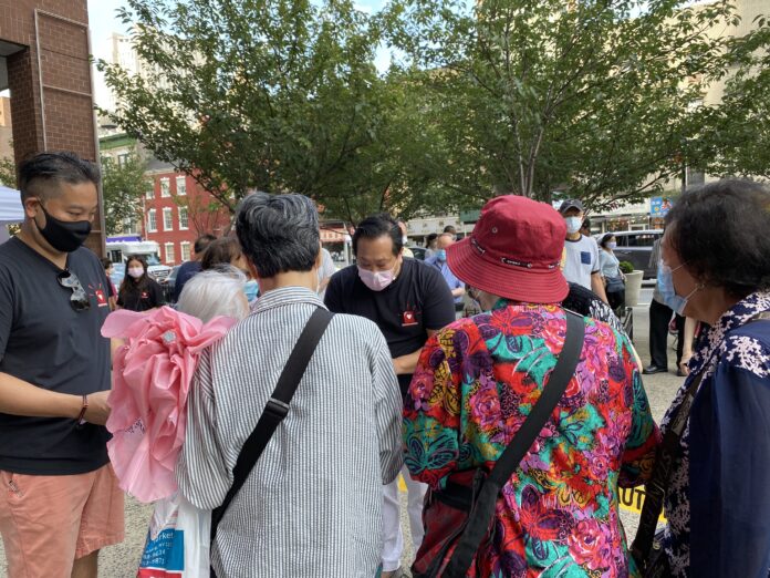 Members of safe from hate give away alarms to Chinatown seniors in New York City