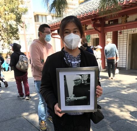 Mounthanus Ratanapakee holds a photo of her father Vicha Ratanapakdee.