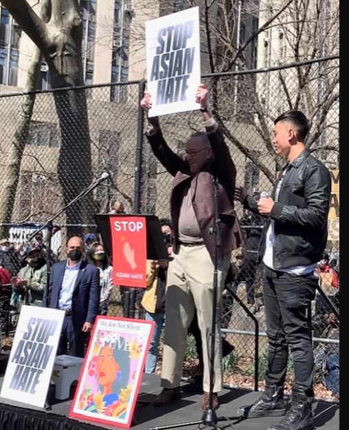 Sen. Charles Schumer holds up sign calling for the country to Stop Asian Hate