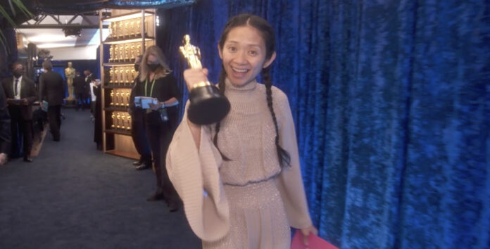 Chloe Zhao clutches her Oscar for Nomadland