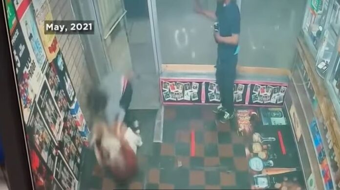 Still from surveillance video of vicious attack by a man using a cinder block to beat two sisters who ran a liquor store in Baltimore.