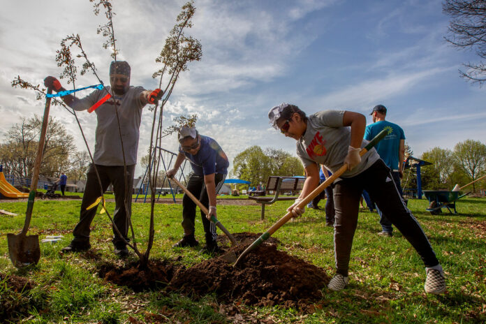 Narinder Johal (left to right) Tarmanjot Johal, and Partaap Johal planted one of eight Autumn Brilliance Serviceberry trees to honor the lives lost at the FedEx shooting in 2021. Over 100 volunteers are planting the other 139 varieties of trees at Arsenal Park, Indianapolis. Keep Indianapolis Beautiful, Inc, and the Eway Foundation of Indianapolis hosted the Great Indy Cleanup & Tree Planting on Saturday, April 23, 2022.