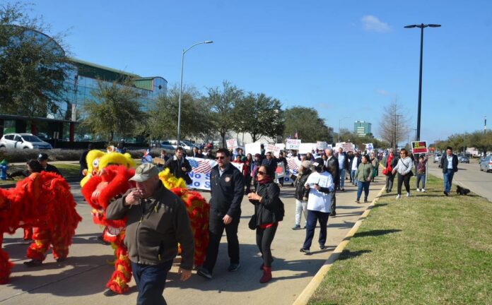A long line of 300 protestors in Texas against a bill banning the purchase of land from four countries including China and North Korea
