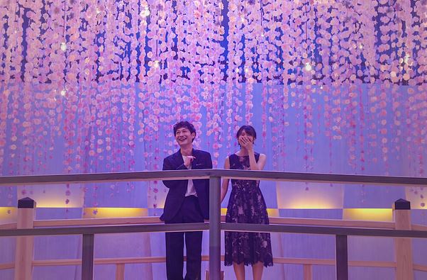 Couple surrounded by lights in a romantic setting on Love is Blind Japan
