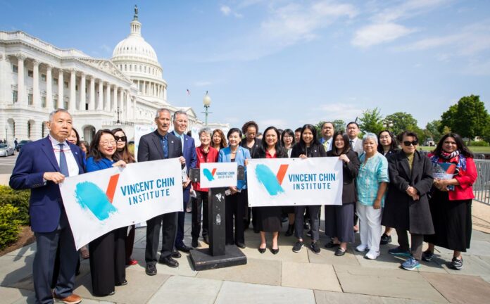 Organizers stand behind banners of the Vincent Chin Institute in front of the Capitol Building in Washington, DC
