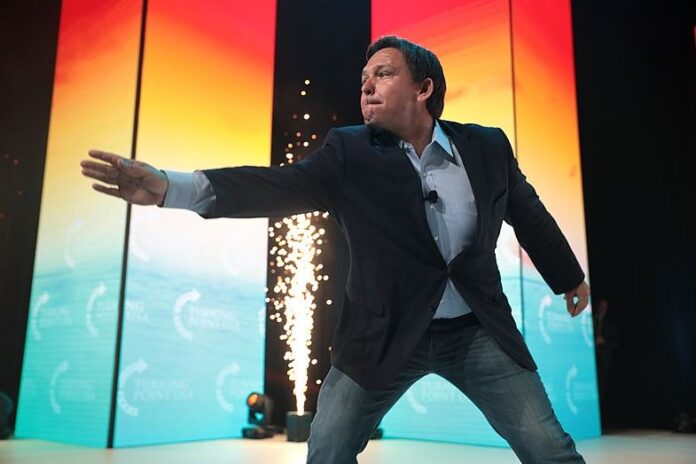 Ron DeSantis is seen here lunging forward at the 2021 Student Action Summit hosted by Turning Point USA at the Tampa Convention Center in Tampa, Florida.