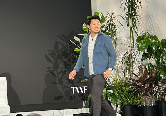 Actor Simu Liu walks on stage at The Asian American Fundation Summit in New York City