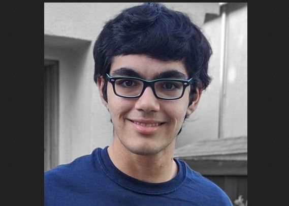 Tanish Mathew Abraham wearing a t-shirt and smiling