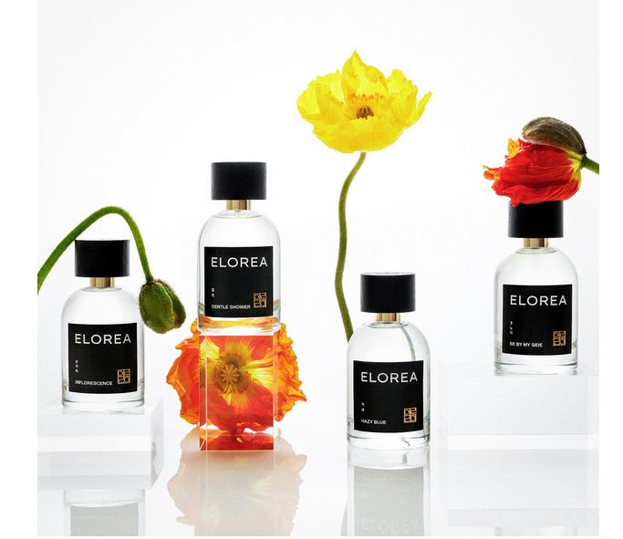 Bottles of Elorea perfume with a flower sticking out