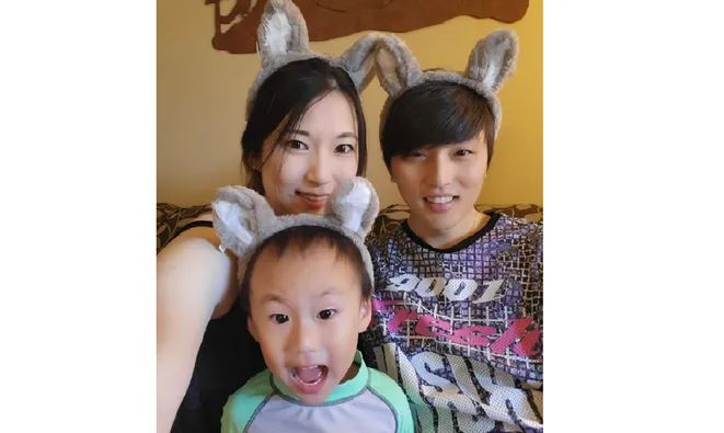 Eina Kwon and Sung -hyun Kwon and their two-year-old son are all seen with bunny ears