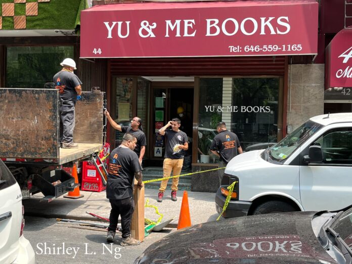 Emergency fire services clean-up crew is scene outside Yu & Me Bookstore on July 8, 2023. Photo: Shirley L. Ng