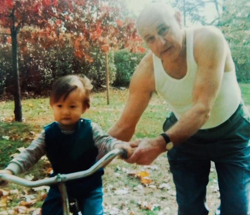 John Kim Faye on bike with dad