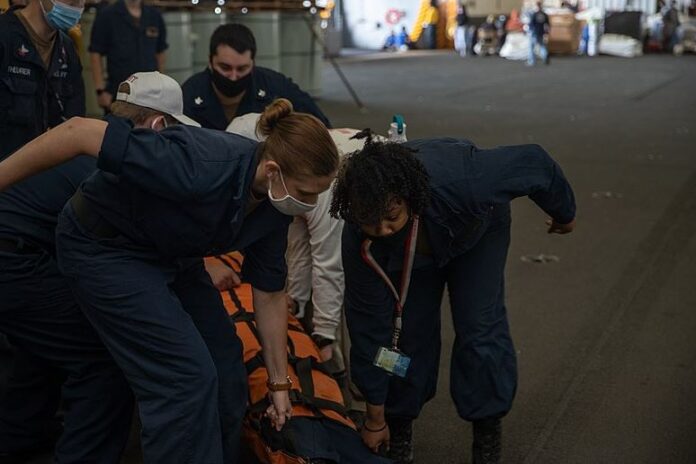 Crews carry a stretcher in an emergency exercise