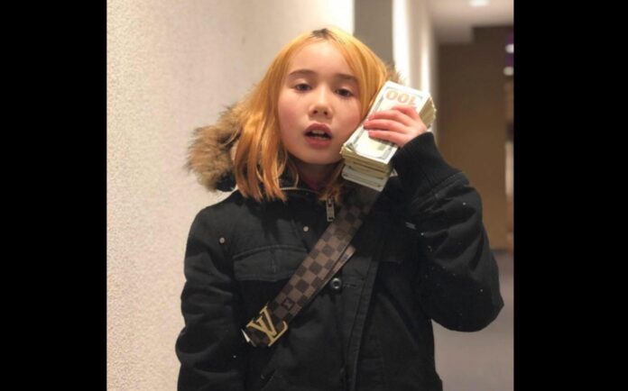 Lil Tay is seen in this Facebook profile photo holding a wad of cash