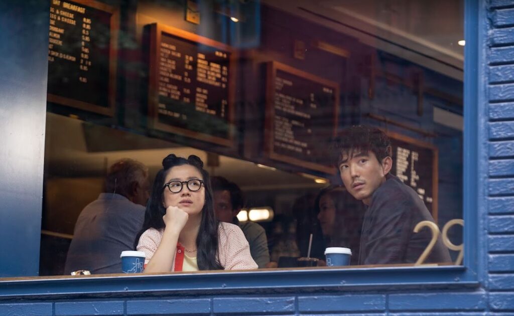 Sherry Cola and Justin H Min stare out fhe window at a cafe in Shortcomings