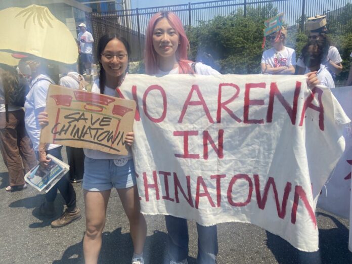 Protesters hold up sign that reads 