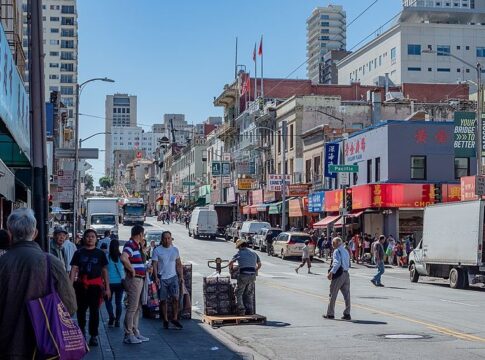 Crowds shop on Stockton Street in San Francisco's Chinatown while hundreds upstairs from the shops lived in one room single family units