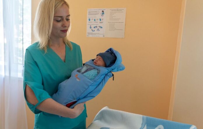 Nurse embraces infant