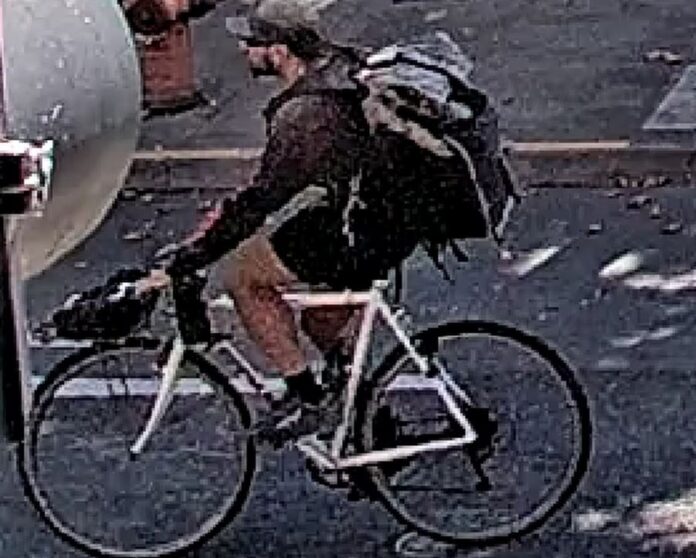 Police in Portland, OR say the man seen here riding a bicycle is suspected in an attack on a business owner and his mother