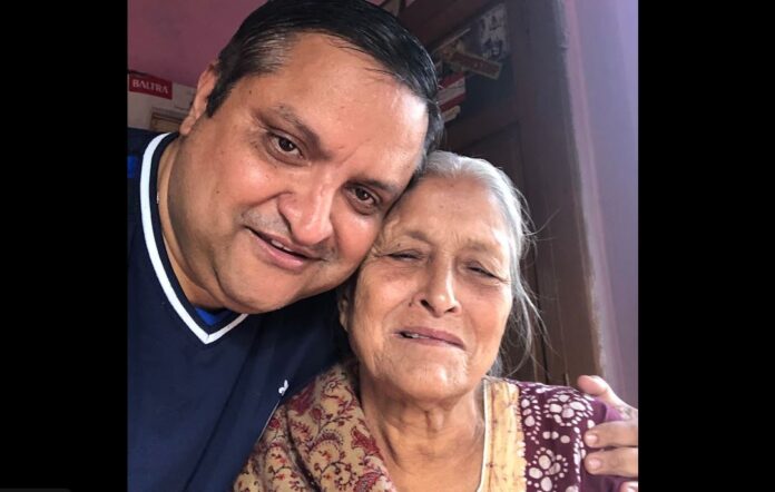 Bijay Khanal takes a selfie with his mother as he wraps his arms around her