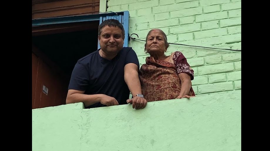 Bijay Khanal poses on the balcony with his mother