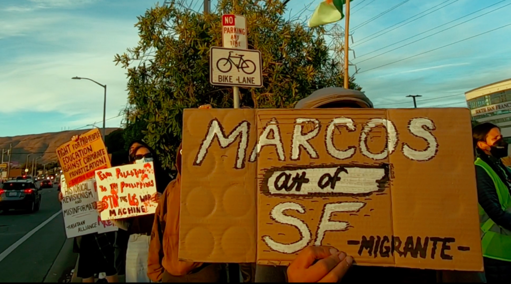 Protestors stood by the side of a busy street on Nov. 14, holding "Marcos Out Of SF" signs in anticipation of the Philippine president's arrival to the city for APEC events. Phtoo by Shanika L. APEC 2023, anti-APEC, No to APEC, anti-Marcos
