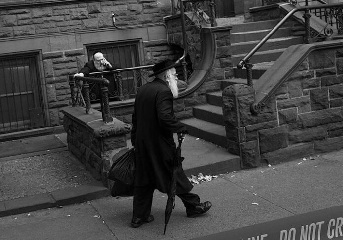 Jewish man walks down the street in Brooklyn