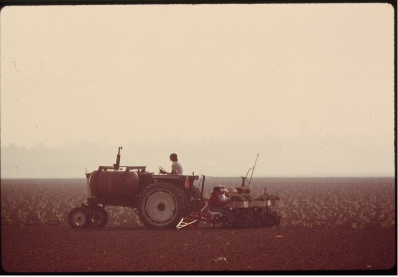 PLANTING A CROP ON OXNARD PLAIN, A PRIME AGRICULTURAL AREA NOW BEING DEVELOPED FOR HOUSING NEAR OXNARD, CALIFORNIA, NORTH OF LOS ANGELES. SOME 84 PERCENT OF THE STATE'S RESIDENTS LIVE WITHIN 30 MILES OF THE COAST, AND THIS CONCENTRATION HAS RESULTED IN INCREASING LAND USE PRESSURE. RESTRICTIONS ON COASTAL DEVELOPMENT WITHIN 1,000 YARDS OF THE SHORELINE WERE TIGHTENED WITH THE PASSAGE OF THE COASTAL ZONE CONSERVATION ACT IN NOVEMBER, 1972