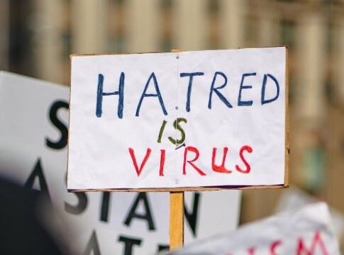 Hatred is a virus sign held up during protest of anti-Asian hate