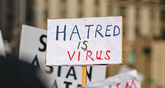 Hatred is a virus sign held up during protest of anti-Asian hate
