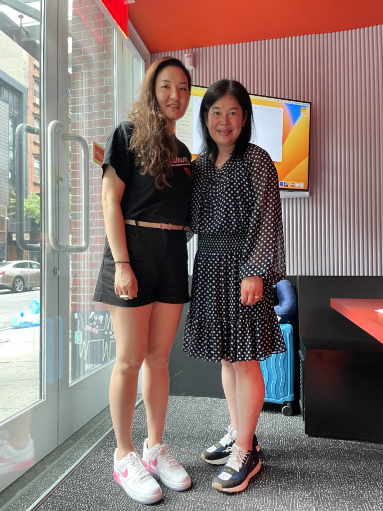 Hannah Kang (left) with Monthanus Ratanapakdee (right), daughter of late "Grandpa Vicha" and founder of Justice 4 Vicha at the community studio where The Tiger in the Room was recorded. Courtesy of Hannah Kang