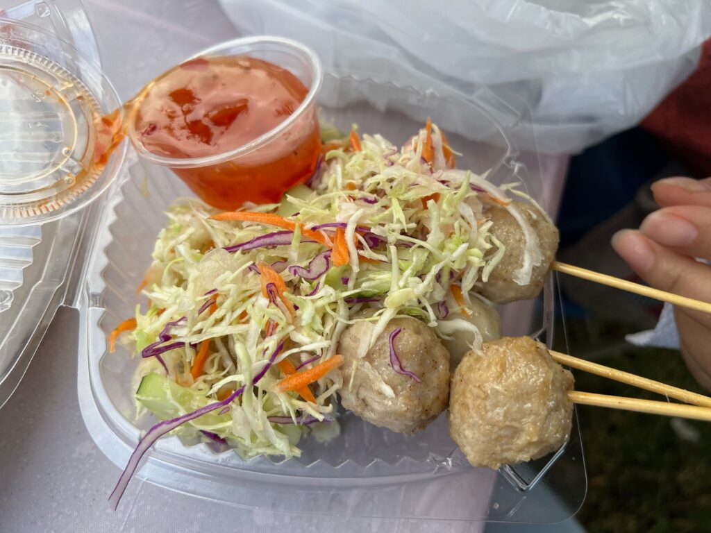 Lao meatballs on a bed of shredded cabbage and lettuce with sweet dip at the Hmong Cultural New Year Celebration. Photo by Jia H. Jung