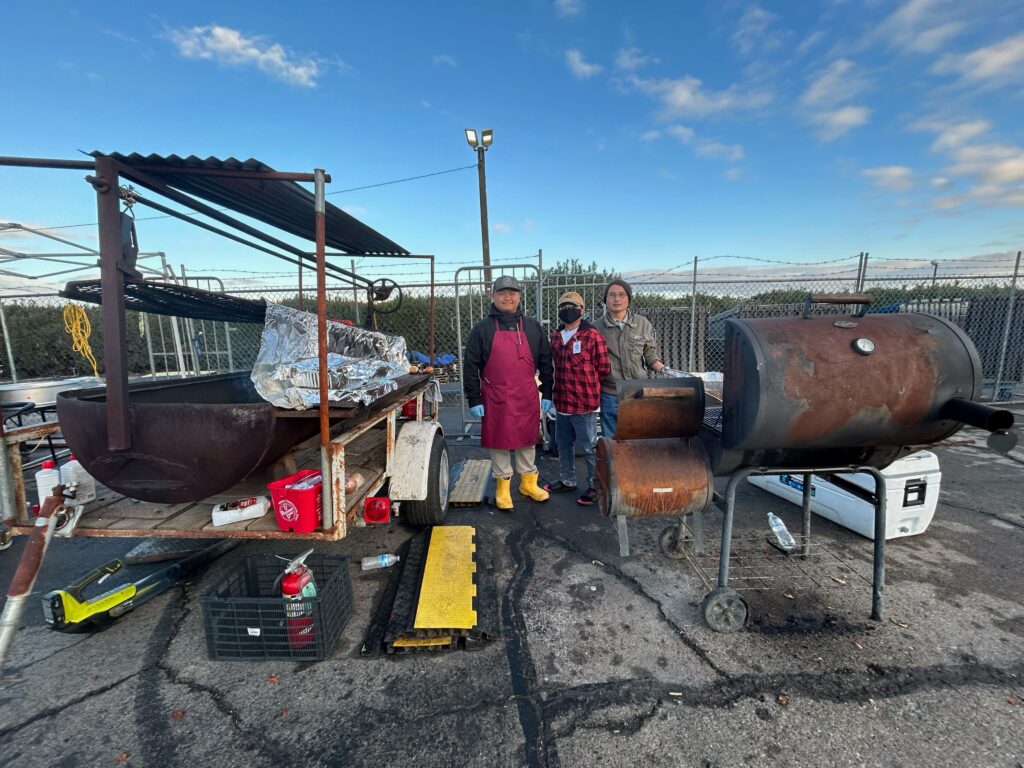 The Hungry Hippo of Fresno behind thier vendor station at the Hmong Cultural New Year Celebration. Photo by Jia H. Jung