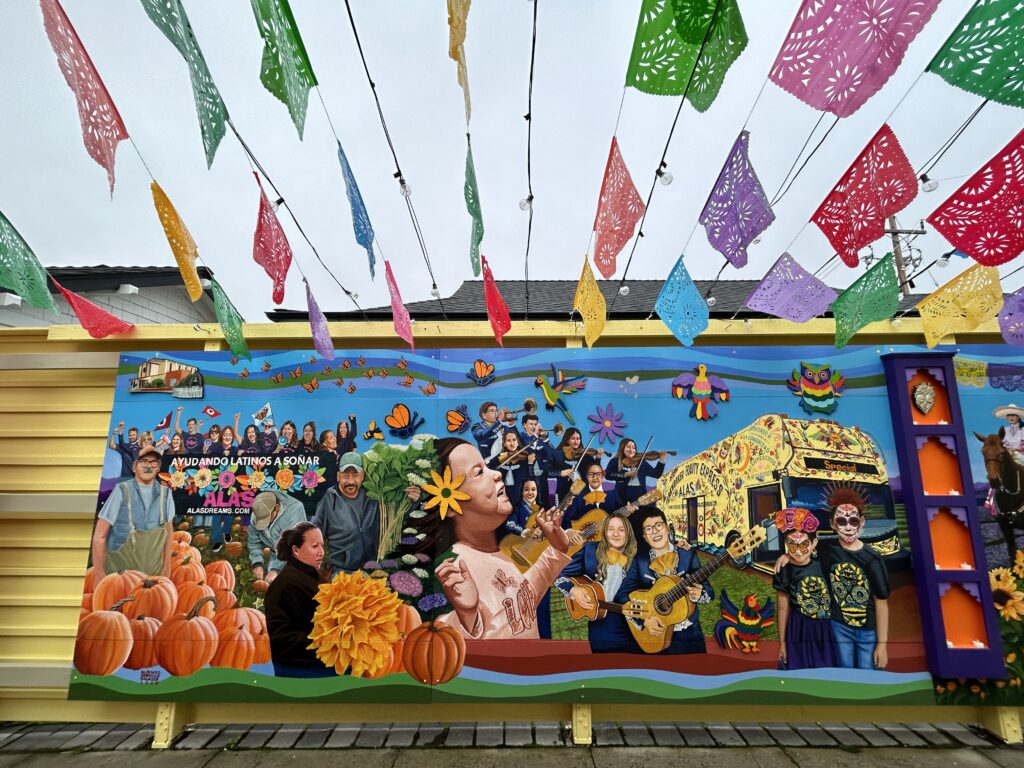 A Mural and streamers outside the Ayudando Latinos a Soñar (ALAS) Casita and Garden in Half Moon Bay before the Corazón del Campesino Memorial Evening commemorating the mushroom farm shootings on Jan. 23