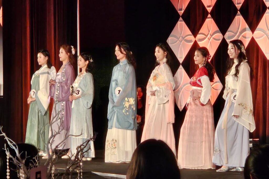 Contestants in the Miss Chicago Chinatown pageant. Eleanor Kang, center in the  blue/turquoise outfit, with her fellow contestants