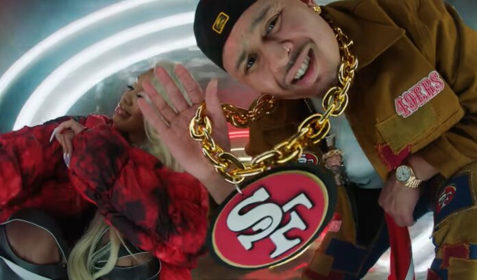 P-Lo adorns a Niner gold chain necklace and Saweetie is dabbed in Niner colors in their music video Do It for the Bay