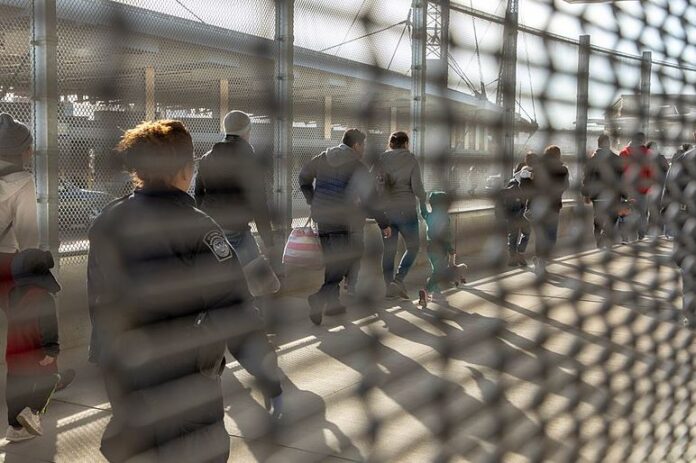 Immigrants, some seeking asylum, are processed by Custom and Border Patrol officers at the San Ysidro Port of Entry.