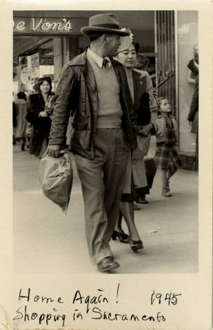 Japanese American couple walking in downtown Sacramento in 1945.