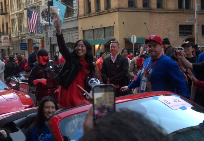 Awkwafina waves to the crowd at the 2024 Chinese New Year Parade.
