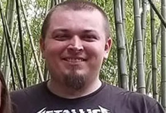 Troy Phillip Bohling poses with trees behind him