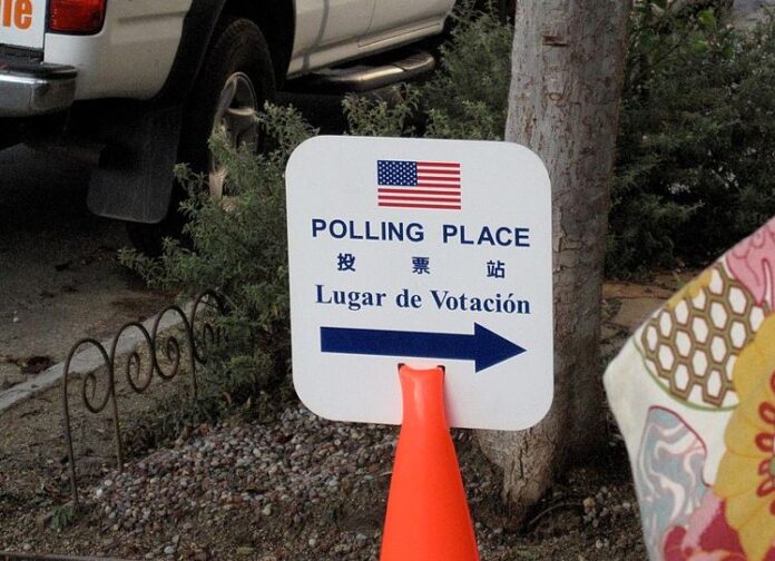 A trilingual sign in English, Chinese and Spanish directs voters to the polls