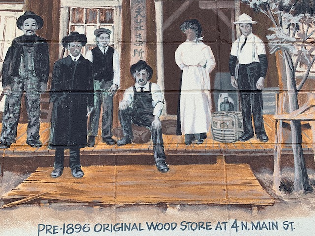 Mural shows storefront with six people